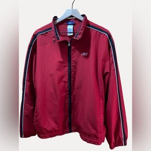REEBOK JACKET
Red and black zip lined windbreaker.

SIZE M